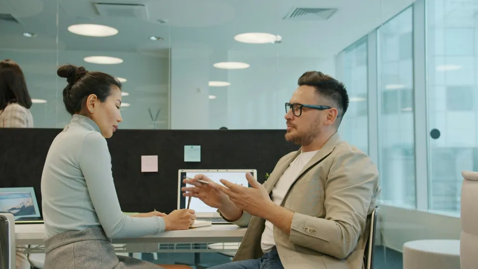 Two people discussing an application in an office