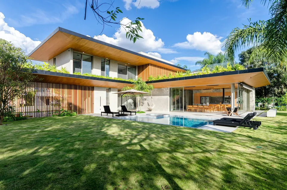 A modern bungalow with a lawn and a swimming pool
